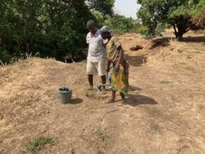 Guillaume planting trees with local women