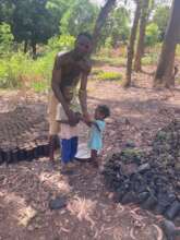 Father planting trees with his children