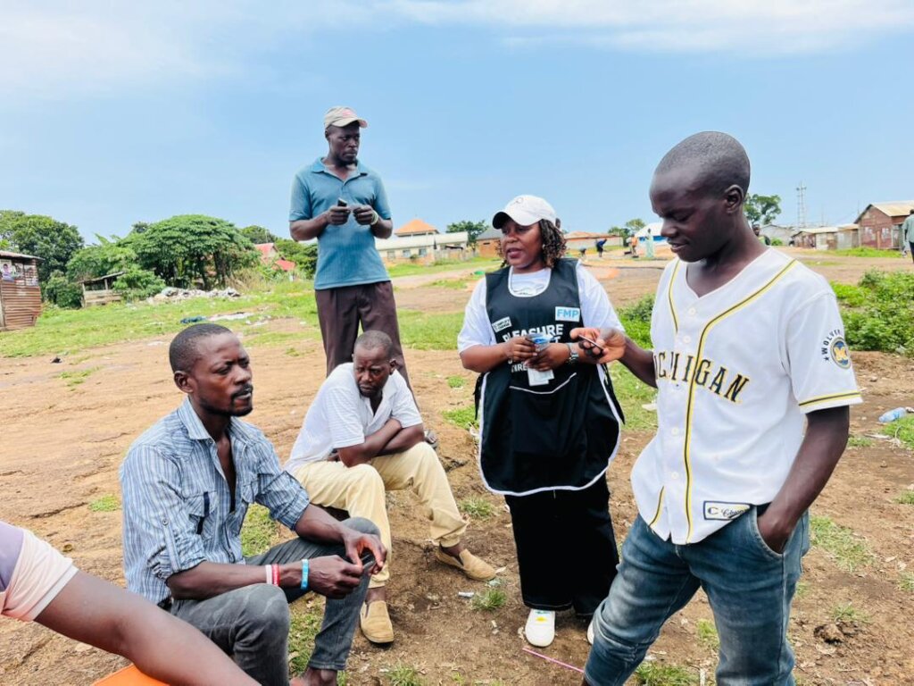 Men engaging with a CPM during the outreach