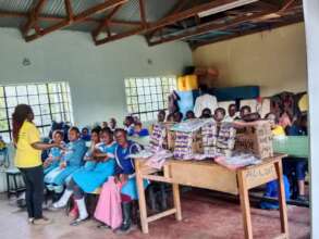 Maureen explain to the girls the need for hygiene