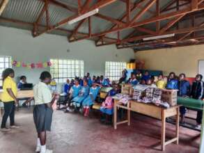 Mercy demonstrating how to wear a sanitary towel