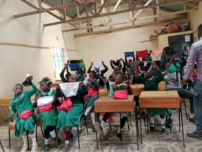 The pupils holding their dignity packs