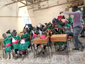 The teacher explaining to them need for hygiene