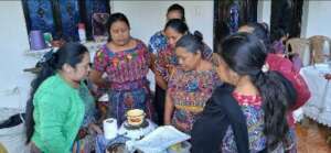 GuateBuena women learn about the efficient stove.