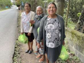 Ladies receive food bags after class