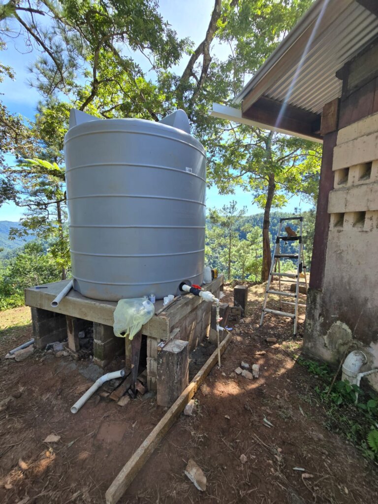 Water tank with platform, gutters and piping