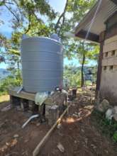 Water tank with platform, gutters and piping