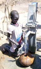Girl getting water at well dug by Water for Sudan