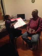 Emmanuel, age nine, practices English with Sherman