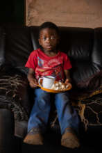 Thando with a plate of food