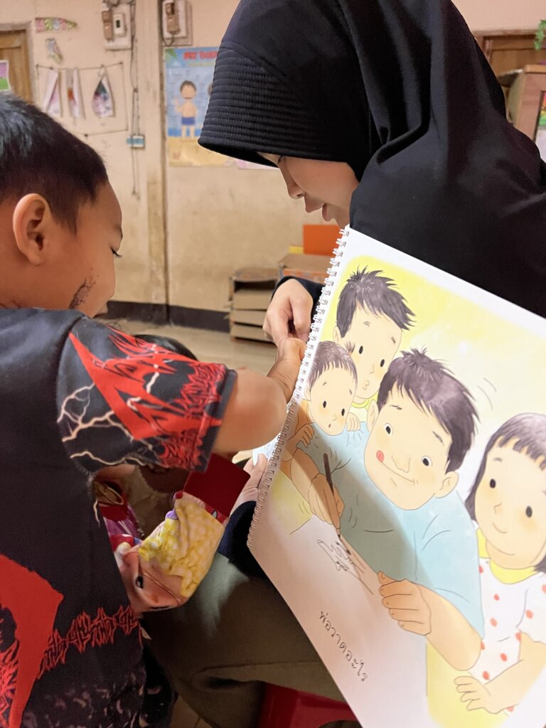 A teacher guides children to learn from books.
