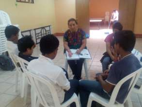 The psychologist working in a small group.