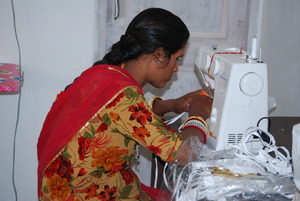 Santosh using electric sewing machine