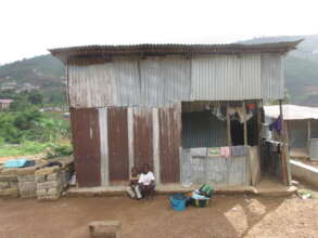 Aminata's younger siblings in front of their home