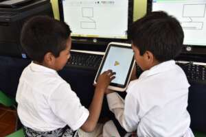 Boys playing with a podcast in tablet.