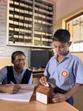 Aarav saving in his school bank piggy bank account