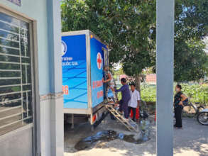 People boarding a mobile X-ray truck in Can Tho
