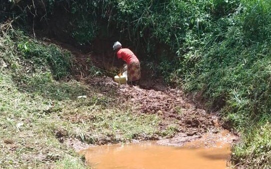 A Woman Collects Water from the New Pipe