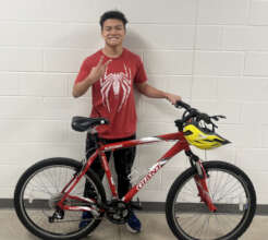 Alan a bike helping him stay in school.