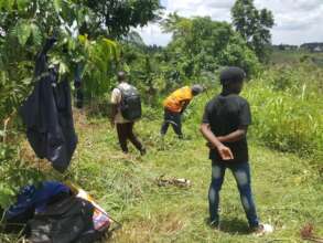 The photo shows local Volunteers cleaning the site