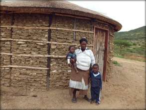 Gcinisephi and her children outside her new house