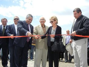 three partners cutting the ribbon