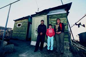 The Sakakyan family outside of their "home"/domik