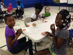 Girls enjoy a free summer meal.
