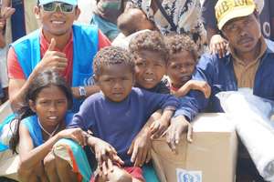 Jalanie (in blue cap) with Typhoon survivors
