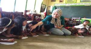 KI volunteer Aisah with children