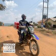 Motorbike transporting tablets to rural schools