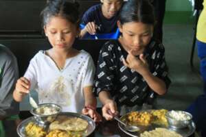 Children receiving nutritious meals.