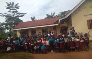 Children infront of the two roomed school building