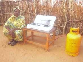Hosna Abker sits by her new butane gas cooker.