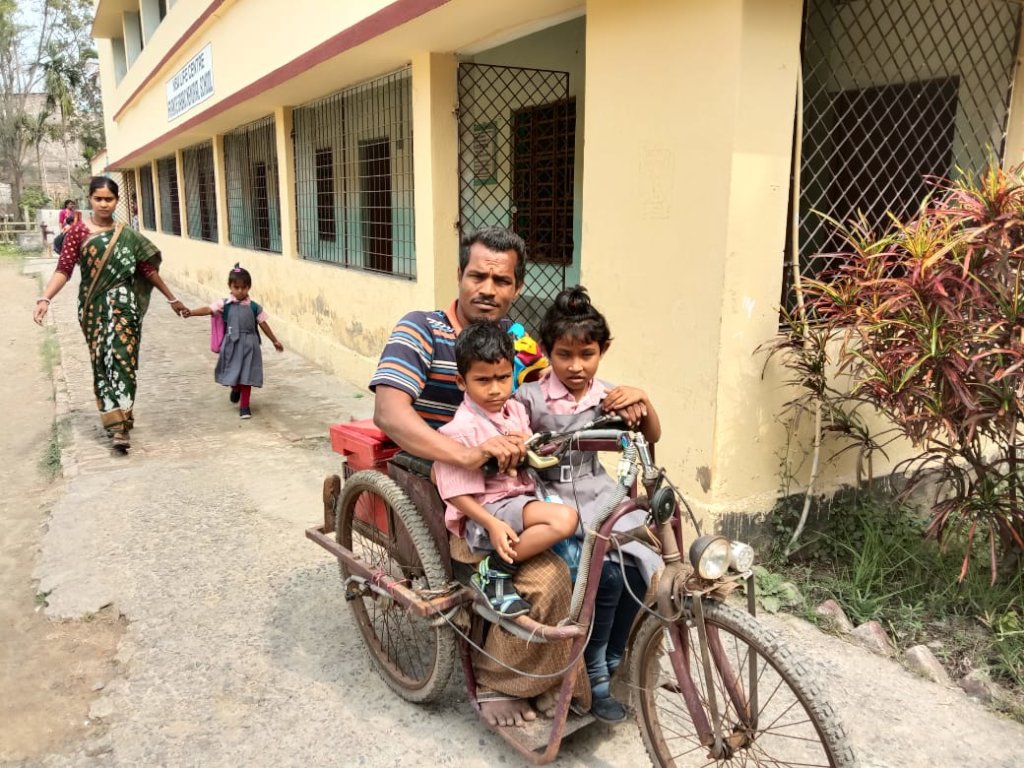 Father bringing children to school
