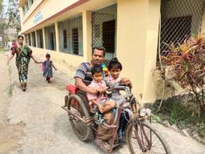 Father bringing children to school