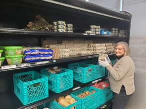 Volunteer Stocking the Pantry
