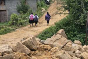 Journey toward education - students walk uphill