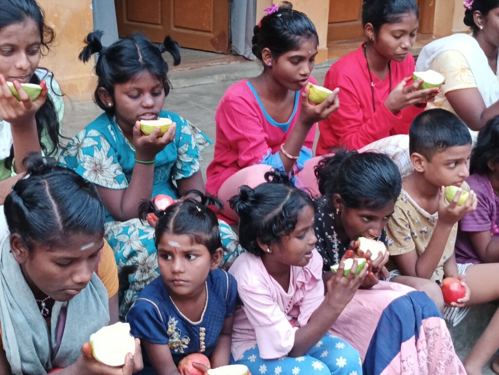 Group of Children having fruits.