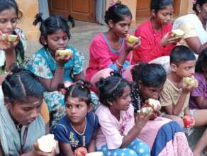 Group of Children having fruits.