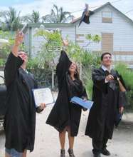 The graduates celebrate with hats flung high