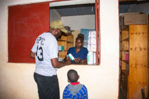 A guardian receives his child's medication