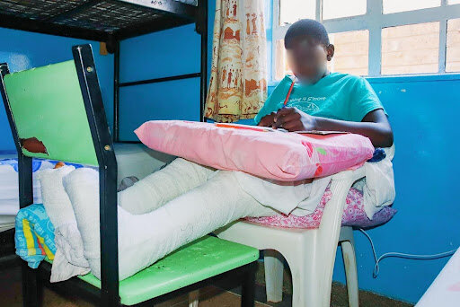 Joel studying at Nyumbani Children's Home