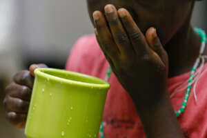 A child taking ARVs at Nyumbani's Respite Care