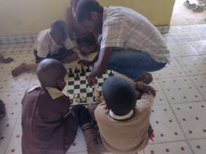 A volunteer teaching learner's chess skills