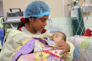 Mother with child post-surgery