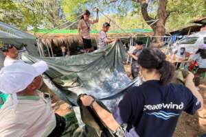 PW staff & volunteers set up field clinic (04/25)