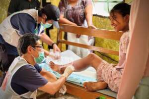 Dr. Inaba treats a patient at Peace Winds' clinic