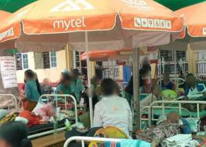 Patients lying on a bed placed outdoors