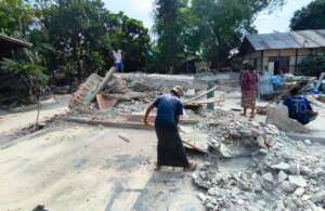 Survivors removing debris